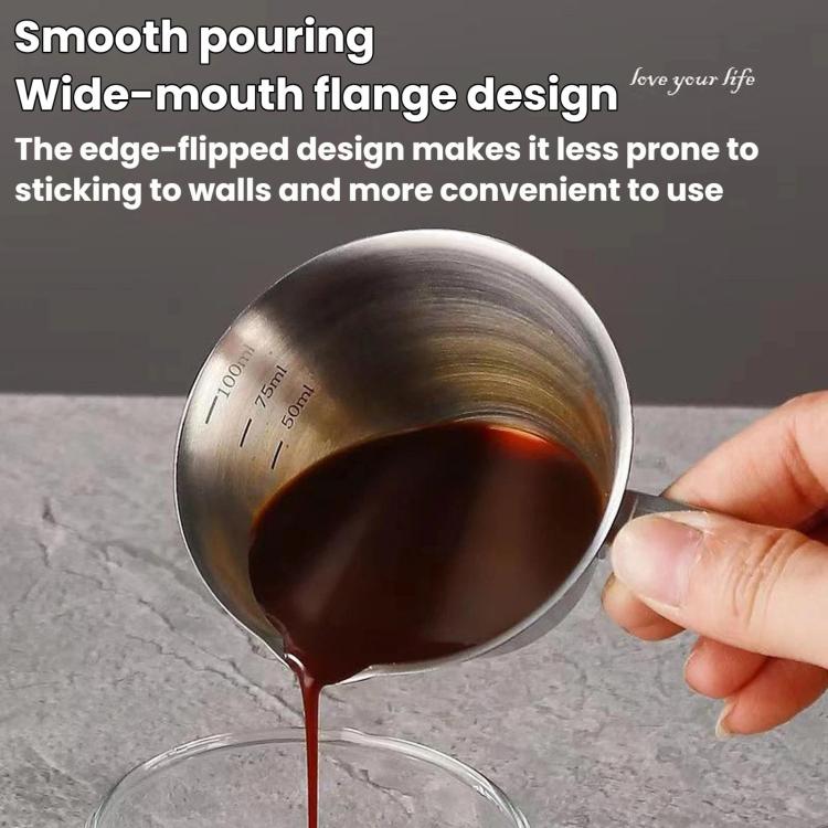 Stainless steel 100ml coffee cup with spout and measurement lines, held while pouring