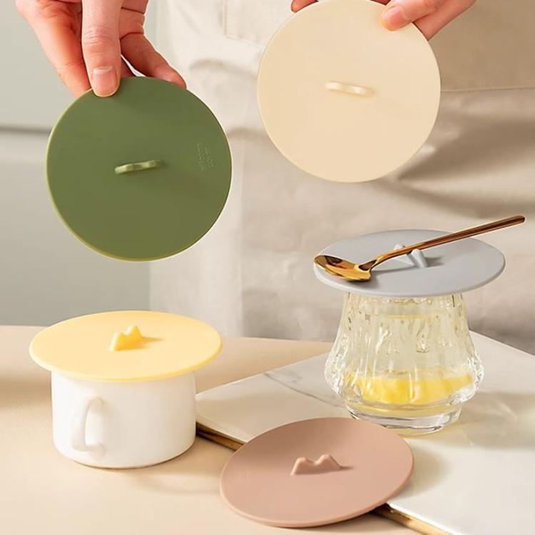 Silicone cup lid set in green, cream, and blush with center handles on cups
