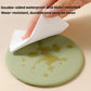 Olive green silicone cup lid with water droplets, wiped clean with cloth