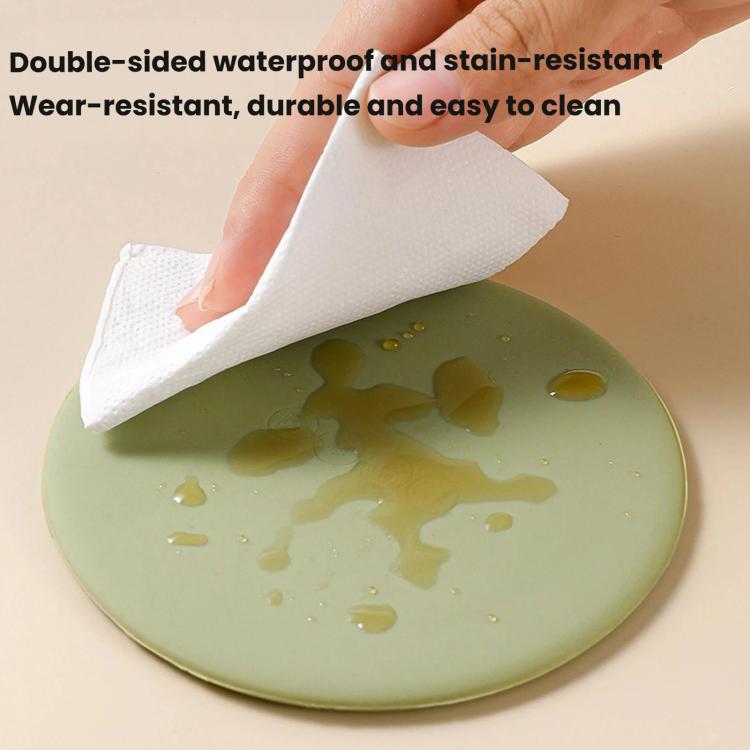 Olive green silicone cup lid with water droplets, wiped clean with cloth