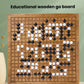 Wooden go board with grid and scattered black and white stones