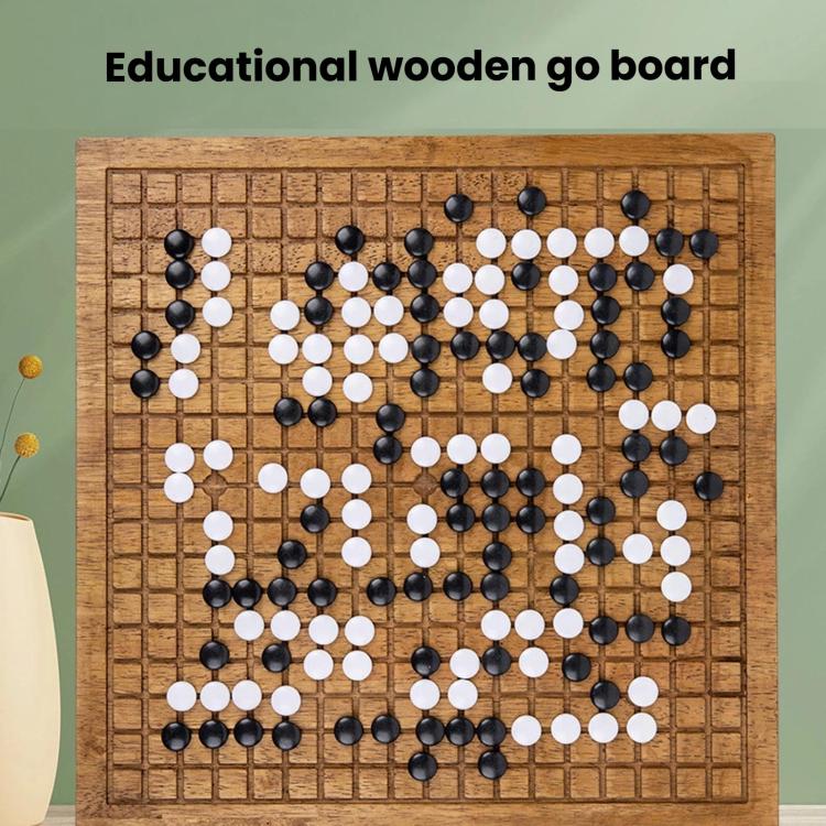 Wooden go board with grid and scattered black and white stones
