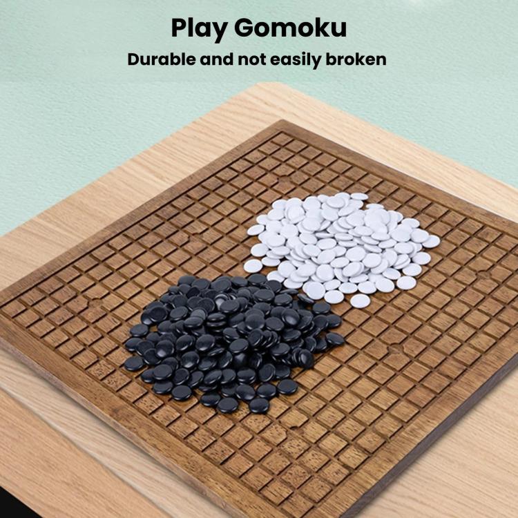 Wooden go board with black and white stones on the playing grid