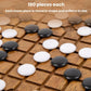 Round black and white game stones on a wooden grid board