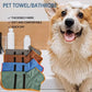Absorbent pet bath robe in green on a dog, with folded blue and brown robes