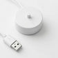 White charging base with central pin and USB power cable