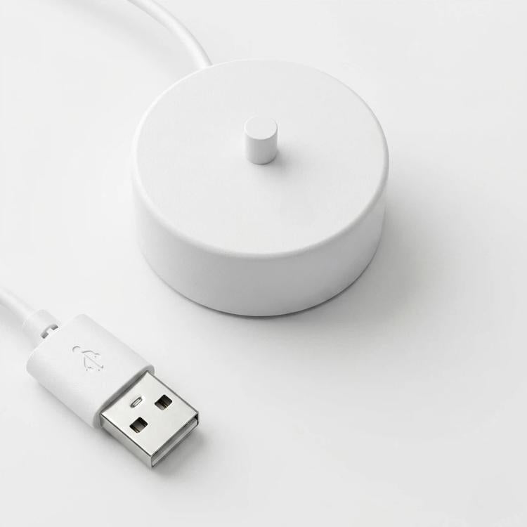 White charging base with central pin and USB power cable