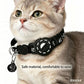 Cat wearing black reflective paw smart tracker collar with bell pendant