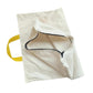 White vacuum dust bag filter with yellow strap and open mouth with black trim