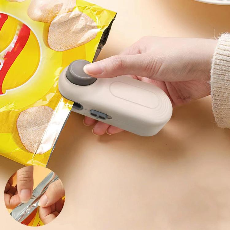 Hand-press mini snack bag sealer, white and gray, with fingers pressing the lid