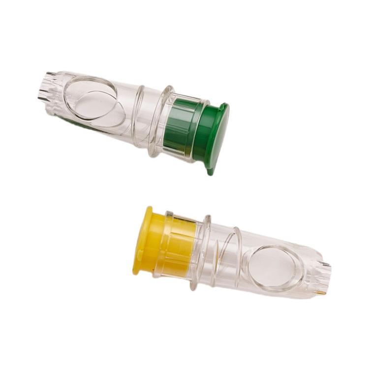 Two manual juicer bottles with clear chambers and green and yellow caps, close-up.