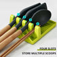 Green spatula storage rack with four slots, holding black-handled scoops