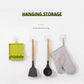 Hanging utensil storage rack holding spatulas, with mounted wall hooks