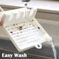 White utensil drainer rack rinsed with water over slotted tray