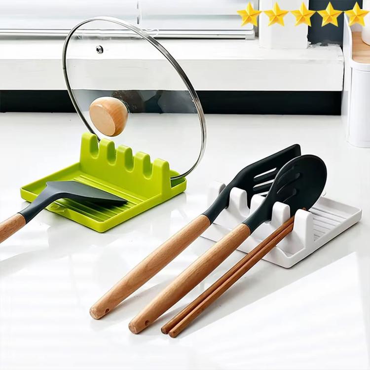 Green and gray utensil storage racks holding spatulas on countertop