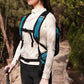 Waterproof cycling backpack in blue with chest strap and front carry handle while worn