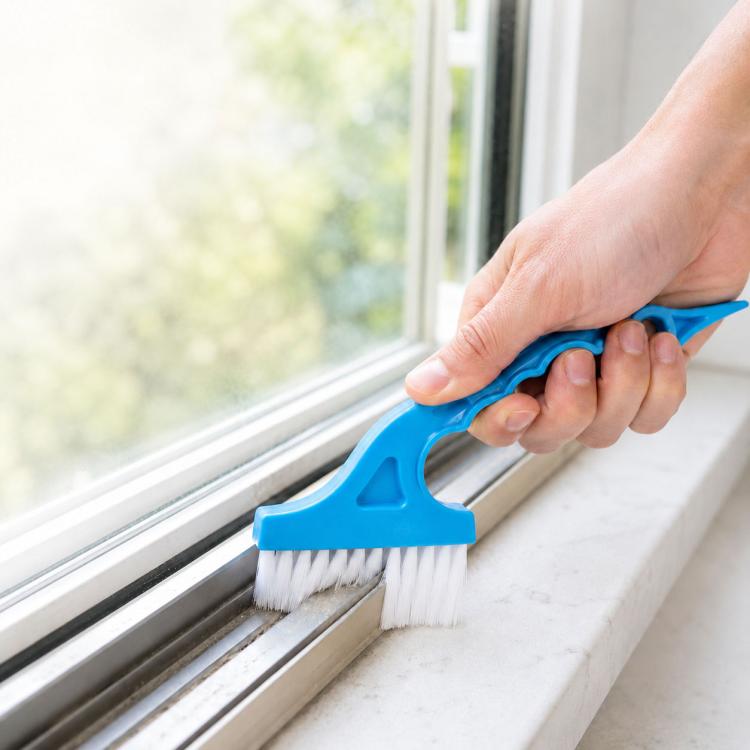 Window track cleaning brush with blue handle and white bristles for groove and edge cleaning