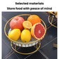 Round wrought iron fruit tray with gold stand holding apples, oranges, lemon, and grapefruit.