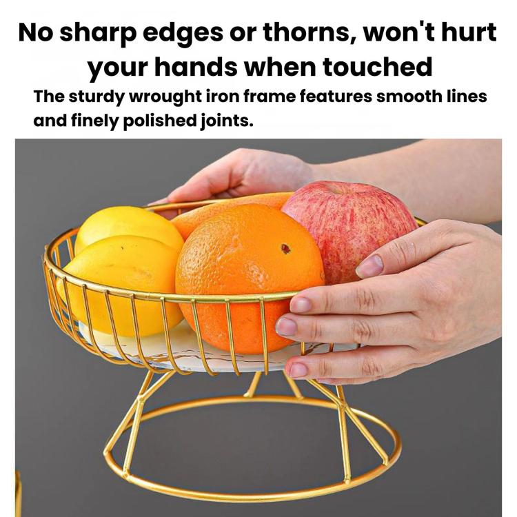 Round wrought iron fruit tray with gold frame and smooth edges, held by hands with fruit.