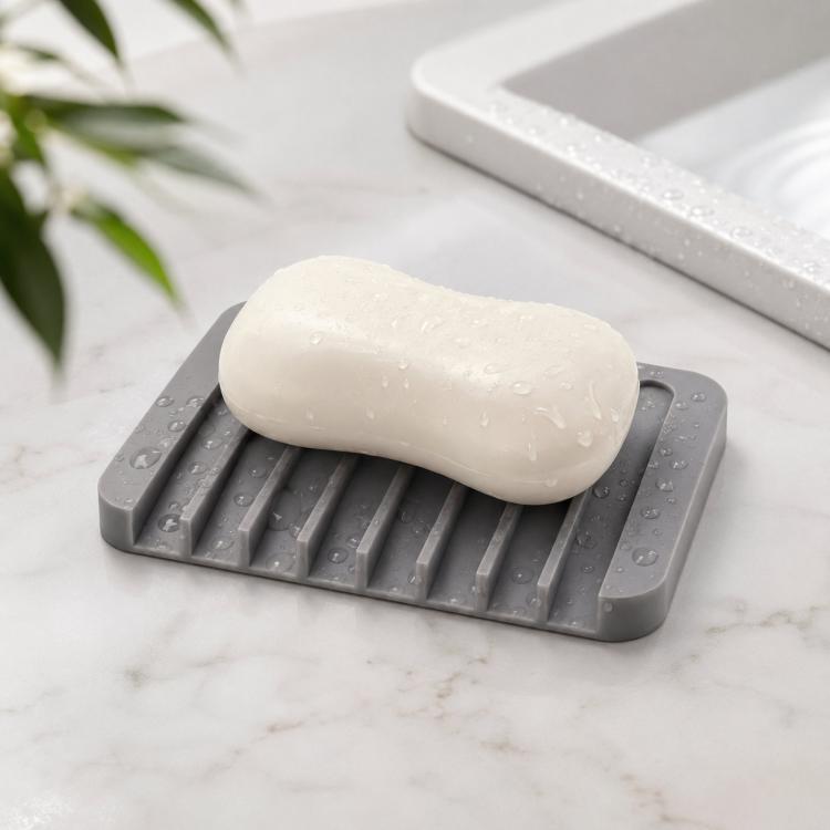 Gray silicone soap dish with raised ridges holding a white bar of soap