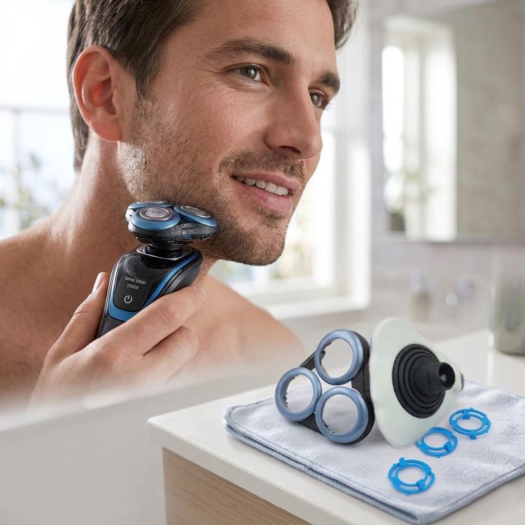 Shaver head retainer cover base with white/light gray cover and blue snap-on rings