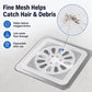 Square white mesh drain hair catcher sticker placed over a metal drain strainer
