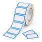 Self-adhesive blank labels roll with blue bordered rectangles and loose label pieces