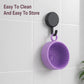 Purple silicone brush cleaning bowl hanging by loop on a wall hook