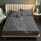 Dark gray waterproof fitted crib sheet with quilted texture and raised edge, 153x203 cm.