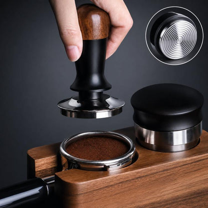 Coffee tamper with walnut wood handle, black body, stainless base pressing into portafilter