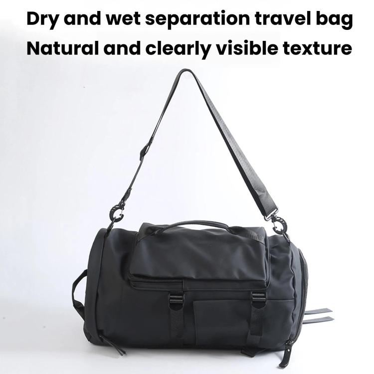 Black duffel-style travel bag with shoulder straps and front zip pocket