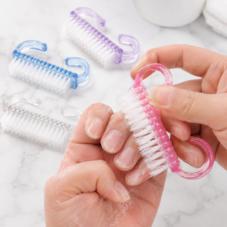 Glitter plastic nail scrub brush with pink horn handle and white bristles