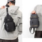 Black sports chest bag worn crossbody with front pocket on a jacket