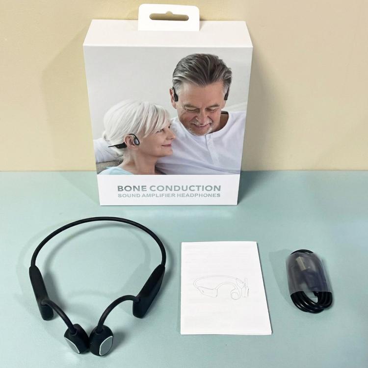 Black bone conduction wireless headphones kit with headset, charging cable, and manual.