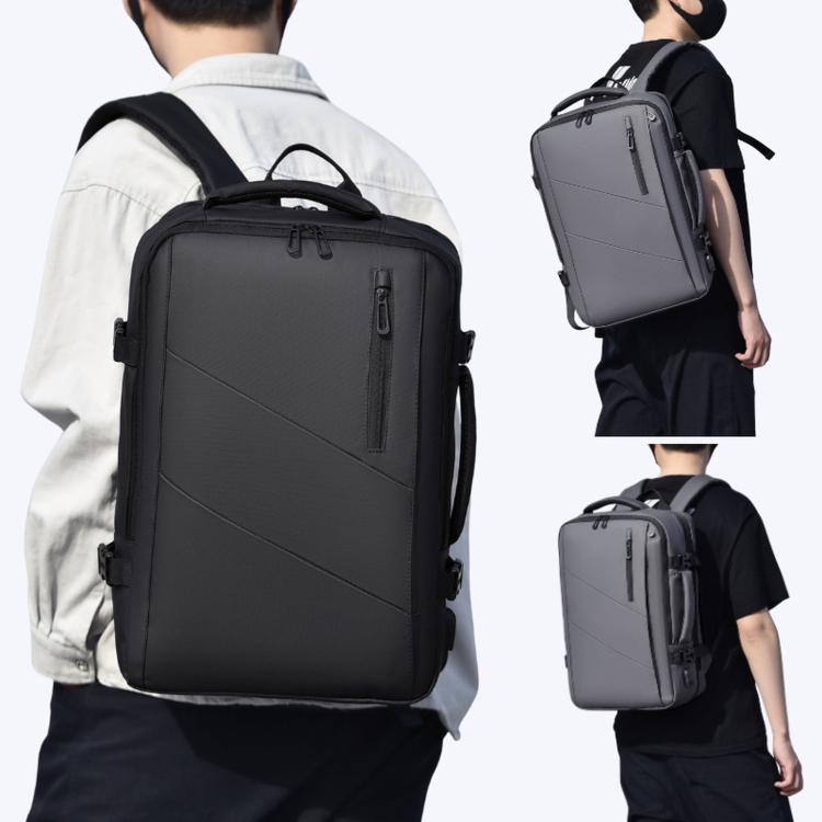 Black laptop backpack with front organizer pocket and side compression straps, on model