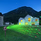 Round in-ground laser garden light projecting a green laser pattern from spike fixture