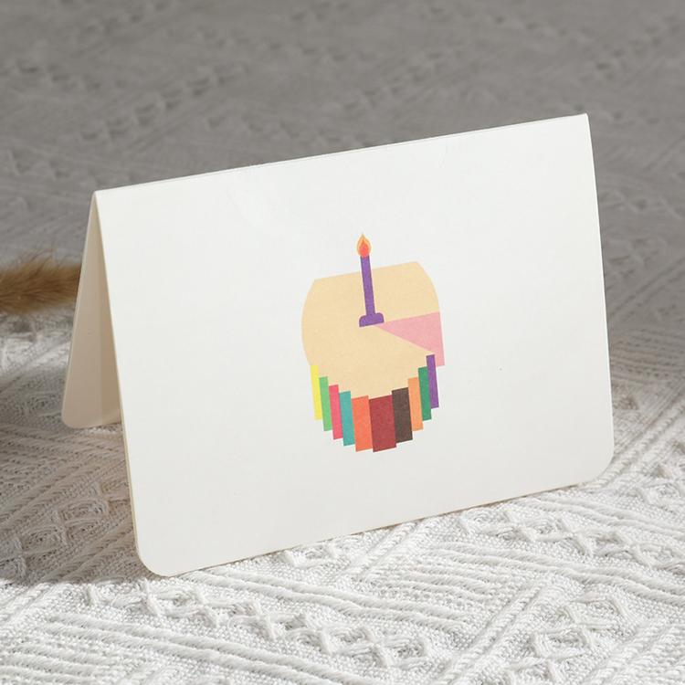 Birthday pop-up greeting card with cake slice and single purple candle