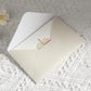Folded birthday pop-up greeting card with small cake design on inner panel