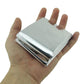 Silver emergency thermal blanket folded in hand, compact travel size