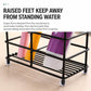 Black toothbrush holder rack with raised feet and slotted ribbed base