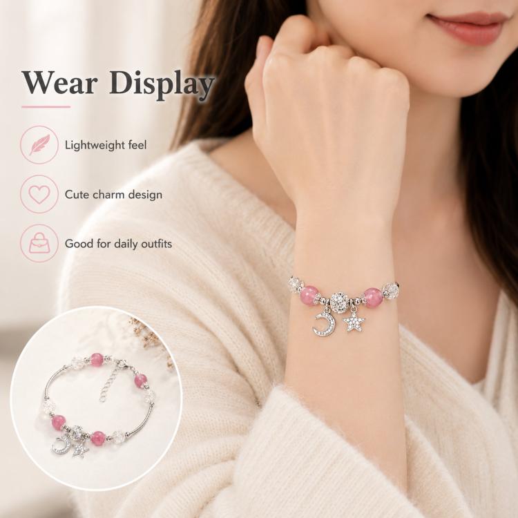 Pink bead bracelet on wrist with crescent moon and star charms and sparkling crystal beads