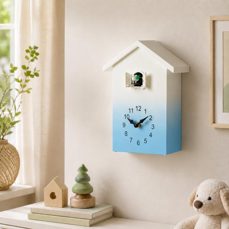 House-shaped wall clock with blue gradient face, black hands, and bird chime window
