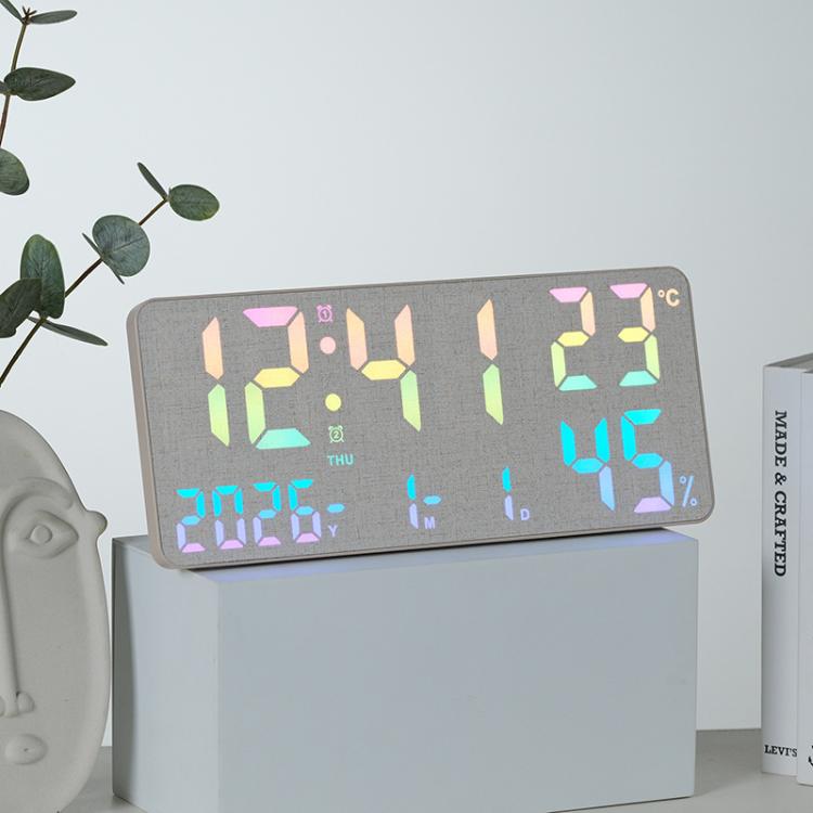 Gray fabric digital wall clock with multi-color LED time, temperature, and humidity display.