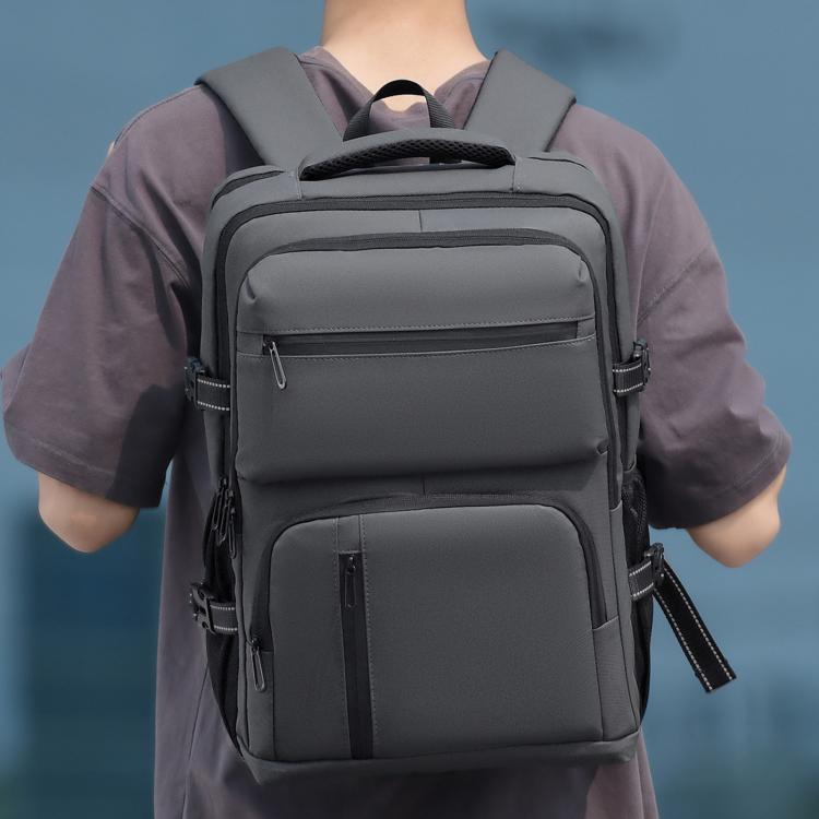 Men's gray backpack worn front view with front pockets and adjustable shoulder straps
