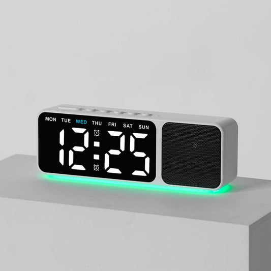 White digital alarm clock speaker with large LED time display and green base glow