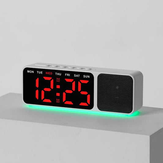 White digital alarm clock speaker with large LED time display and red digits, green glow