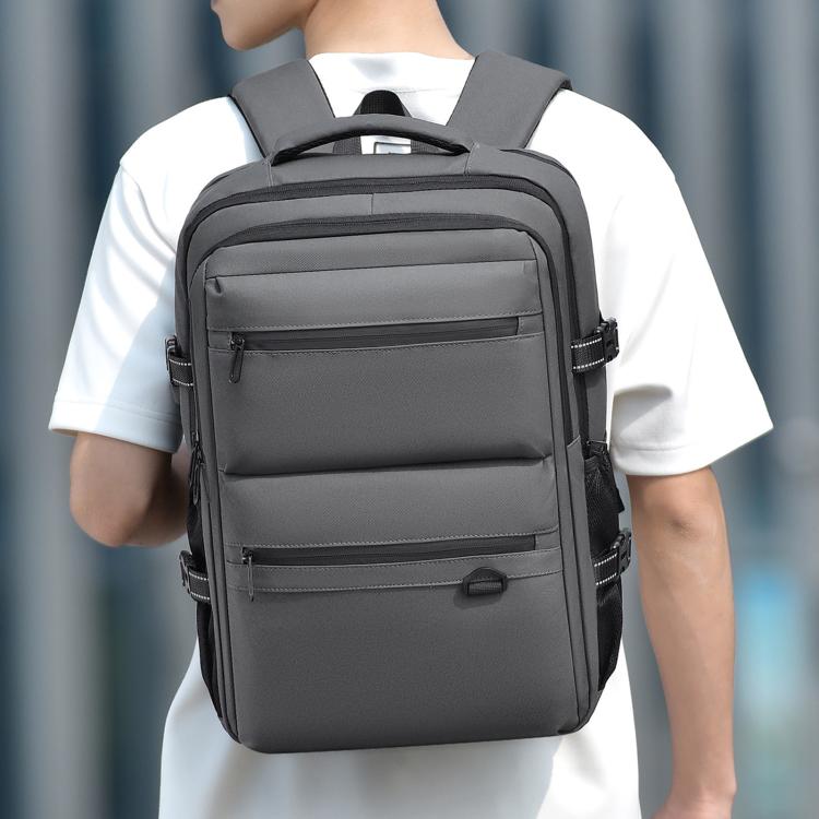 Gray waterproof laptop backpack with front zip pockets and adjustable shoulder straps