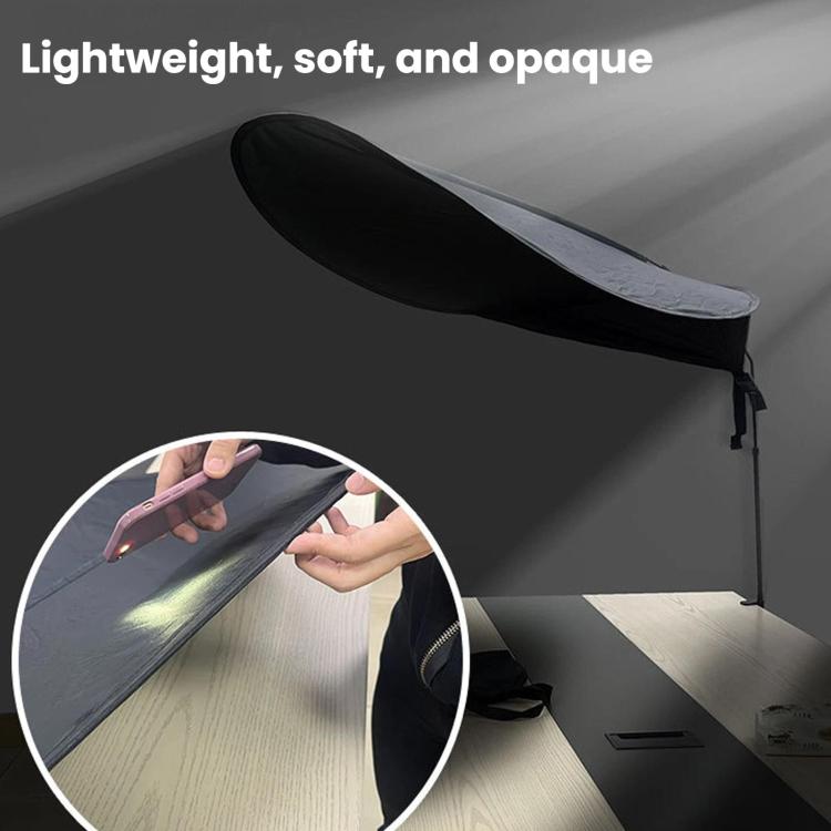 Black opaque indoor sunshade curtain with clamp pole, shown folded edge close-up