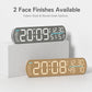 LED digital alarm clock showing two finishes: dark fabric face and wood-grain face