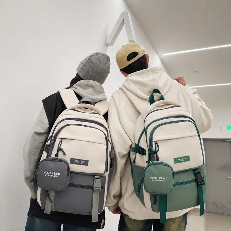 Set of two school backpacks with front coin pouches, one gray and one green